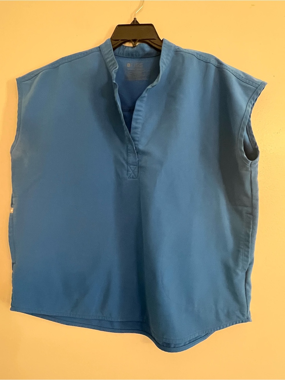 FIGS Rafaela oversized sleeveless scrub top with a Mandarin collar and V-necklin